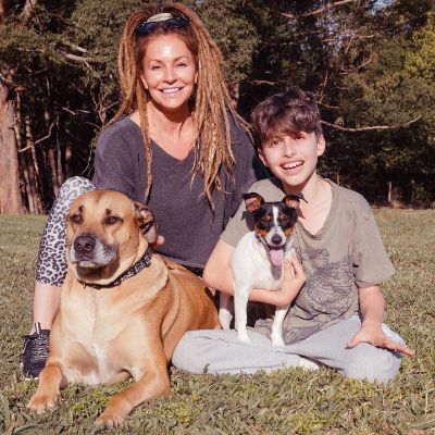 Photo of Simmone Jade Mackinnon along with her son and two dogs. 